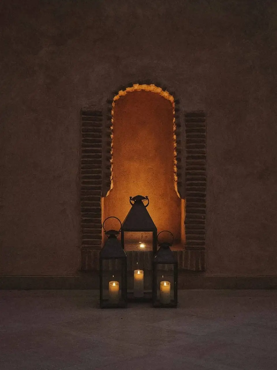 Lanterns lit at dusk in a Moroccan doorway